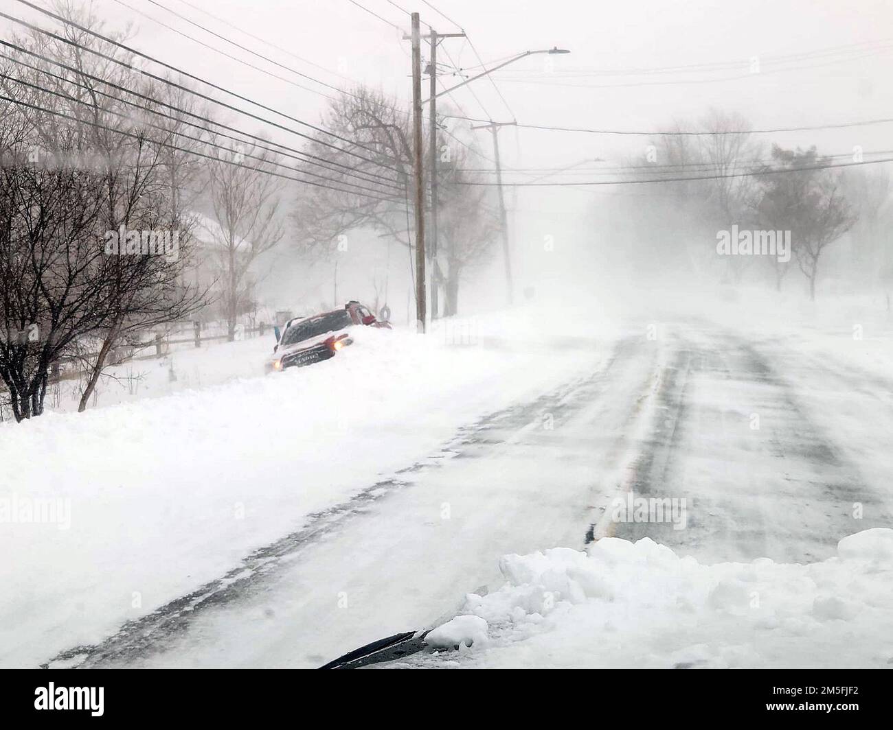 December 24, 2022, Lancaster, New York, USA A car is stuck in the snow