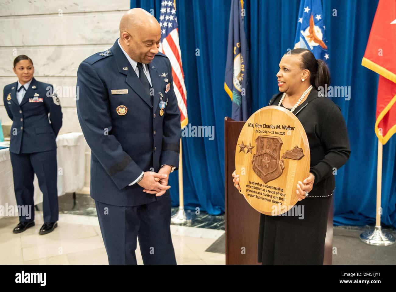 Sheila Lawson, state equal employment manager for the Kentucky National Guard, presents Maj. Gen. Charles M. Walker, director of the Office of Complex Investigations at the National Guard Bureau, with a token of appreciation during Walker’s promotion ceremony, held in the Capitol Rotunda in Frankfort, Ky., March 12, 2022. Walker previously served as chief of staff for the Kentucky Air National Guard. Stock Photo