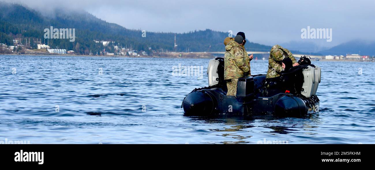 Navy explosive ordnance disposal technicians, assigned to Explosive Ordnance Disposal Mobile Unit (EODMU) 1, conduct safety checks prior to dive operations to reacquire, identify and neutralize inert mine shapes in the Gastineau Channel near Juneau, Alaska, March 13, 2022, as part of Exercise ARCTIC EDGE 2022. Navy EOD training builds a more agile and resilient force to ensure the fleet and joint force can access, fight and win, anywhere and anytime the nation needs. AE22 is a defensive exercise for U.S. Northern Command and Canadian Armed Forces designed to demonstrate and exercise our abilit Stock Photo