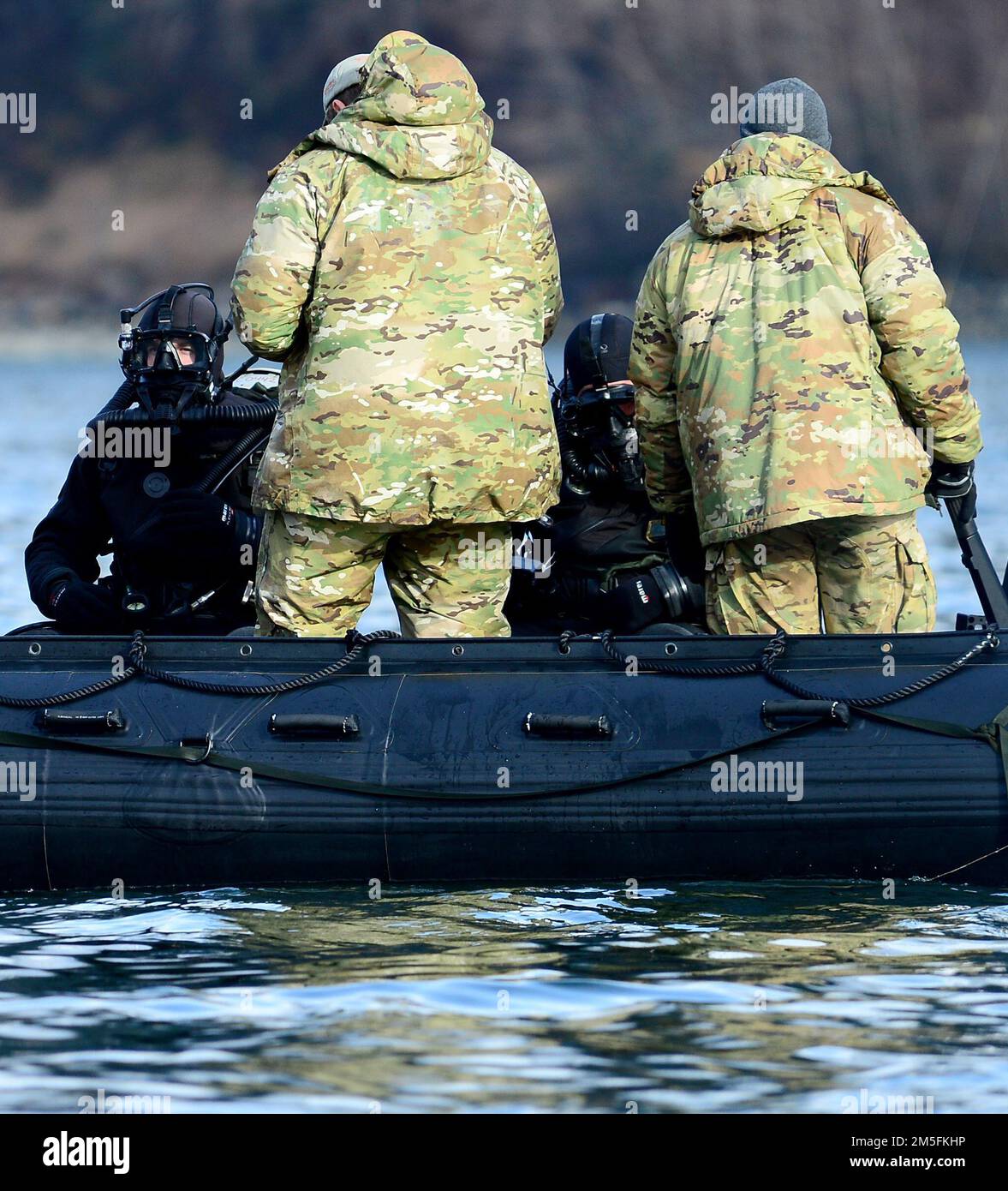 Navy explosive ordnance disposal technicians, assigned to Explosive Ordnance Disposal Mobile Unit (EODMU) 1, conduct safety checks prior to dive operations to reacquire, identify and neutralize inert mine shapes in the Gastineau Channel near Juneau, Alaska, March 13, 2022, as part of Exercise ARCTIC EDGE 2022. Navy EOD training builds a more agile and resilient force to ensure the fleet and joint force can access, fight and win, anywhere and anytime the nation needs. AE22 is a defensive exercise for U.S. Northern Command and Canadian Armed Forces designed to demonstrate and exercise our abilit Stock Photo