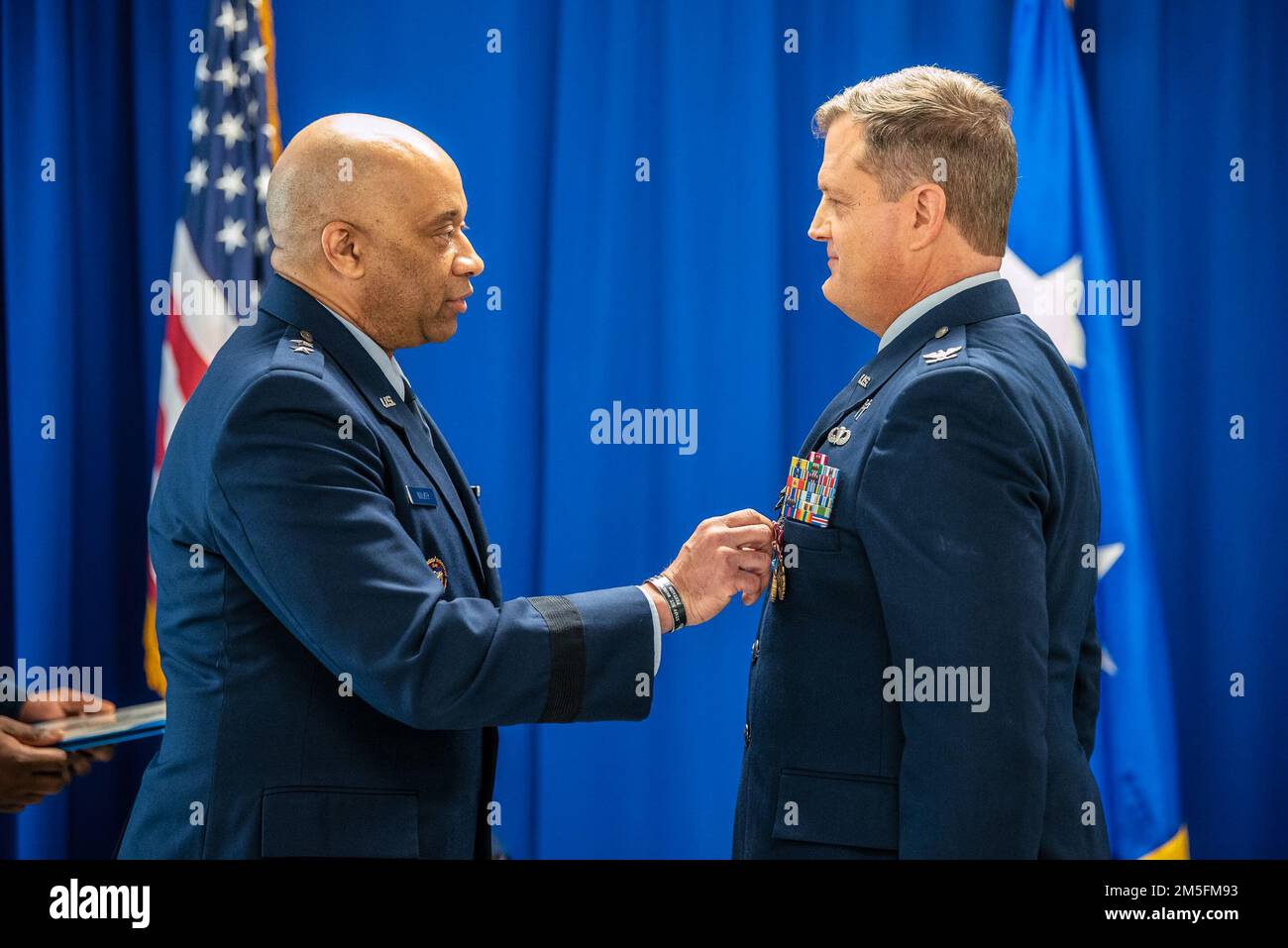 Major Gen. Charles Walker, left, director of the Office of Complex Investigations at the National Guard Bureau, pins a Kentucky Distinguished Service Medal to Col. Fred Ehrman’s uniform during Ehrman’s retirement ceremony at the Kentucky Air National Guard Base in Louisville, Ky., March 13, 2022. Ehrman, assistant to the command chaplain at United States Air Forces Europe and Air Forces Africa, served as a chaplain at the Kentucky Air National Guard’s 123rd Airlift Wing for 16 years. Stock Photo