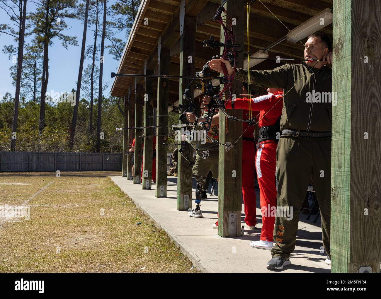 U.S. Marines with Wounded Warrior Battalion East participate in the 2022 East Coast Marine Corps Trials archery competition on Marine Corps Base Camp Lejeune, North Carolina, March 14, 2022. The Marine Corps Trials is an annual adaptive sports competition that promotes a competitive warrior spirit, builds camaraderie and provides a venue to select participants for the 2022 DoD Warrior Games. Stock Photo