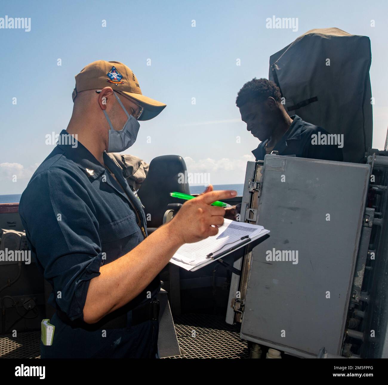 SOUTH CHINA SEA (March 14, 2022) Izaiah Irby, from Greenville, S.C., checks the exterior temperature aboard the Arleigh Burke-class guided-missile destroyer USS Ralph Johnson (DDG 114). Ralph Johnson is assigned to Task Force 71/Destroyer Squadron (DESRON) 15, the Navy’s largest forward-deployed DESRON and the U.S. 7th fleet’s principal surface force. Stock Photo