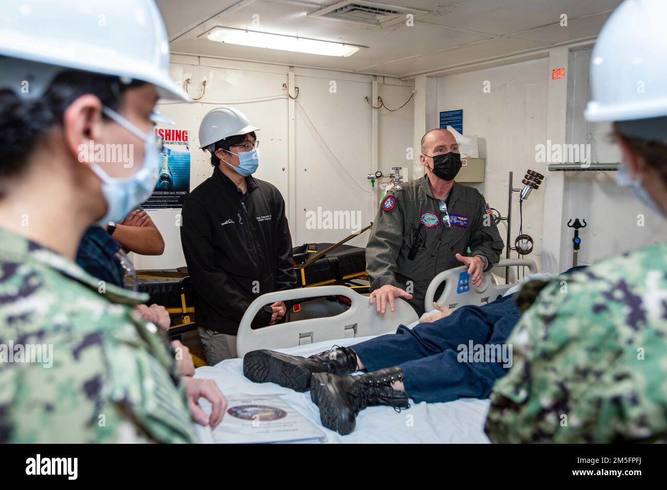 220314-N-NW981-1095 YOKOSUKA, Japan (March 14, 2022) Capt. Merrill Rice, senior medical officer aboard the U.S. Navy’s only forward-deployed aircraft carrier USS Ronald Reagan (CVN 76), gives a Medical department tour to U.S. Naval Hospital Yokosuka (USNHY) physicians and Japanese fellowship program physicians. Fellowship program physicians learn outpatient and inpatient medicine, as well as serve as medical liaisons between USNHY and local Japanese hospitals. Ronald Reagan, the flagship of Carrier Strike Group 5, provides a combat-ready force that protects and defends the United States, and s Stock Photo