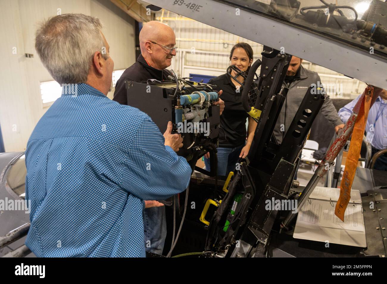 Engineers install modular ejection seat components during an ejection ...