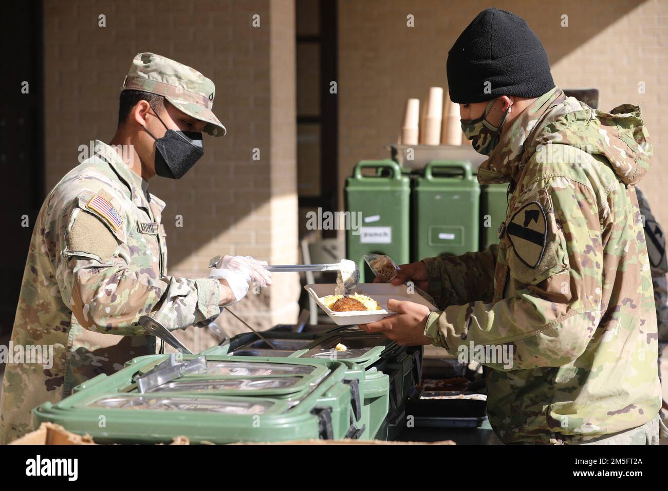 Culinary specialists with 1st Armored Brigade Combat Team feed troopers