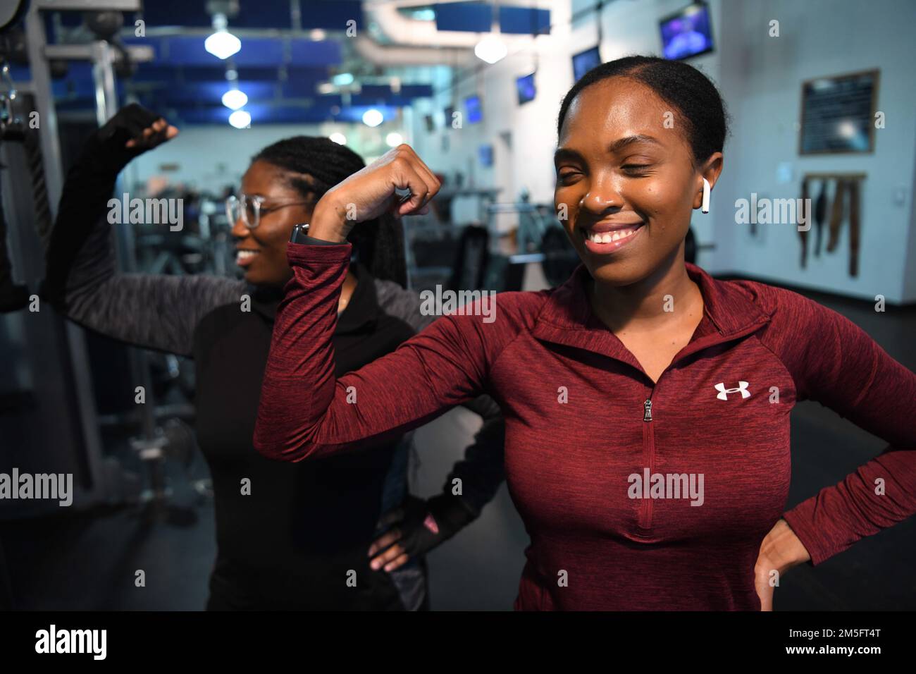 Senior Airman Jimara Palmer, missile security operator at the 890th Missile Security Forces Squadron (left), and Senior Airman Lashonda Schlis, flight security controller at the 890th Missile Security Forces Squadron (right), pose while working out at F.E. Warren Air Force Base, Wyoming, March 15, 2022. This image was captured in efforts to bring awareness to international women’s month. Stock Photo