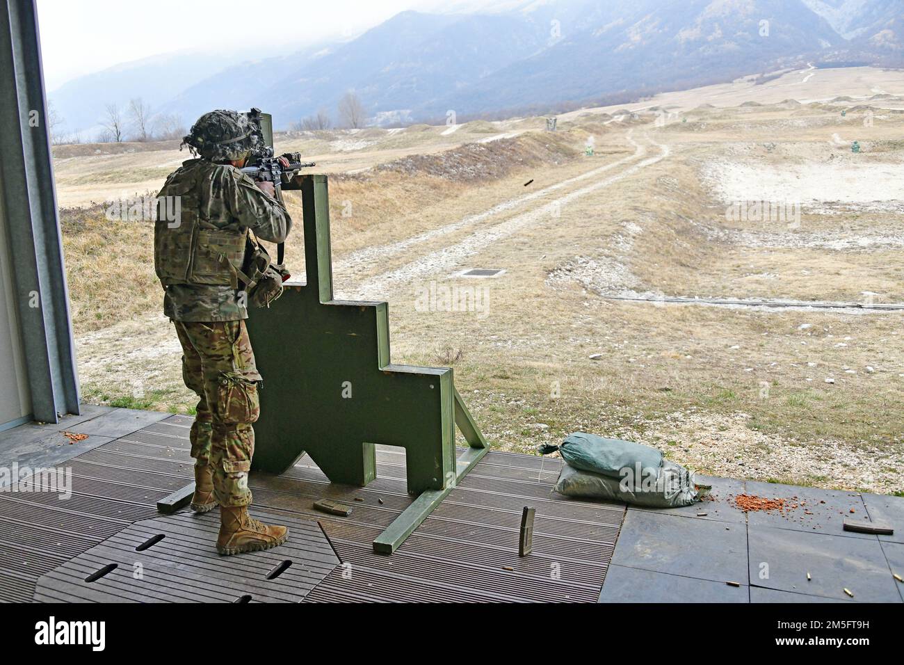A U.S. Army Paratrooper, assigned to the 2nd Battalion, 503rd Infantry Regiment, 173rd Airborne Brigade, engages a pop-up targets with  an M4 carbine during marksmanship training at Cao Malnisio Range, Pordenone, Italy, March 15, 2022. The 173rd Airborne Brigade is the U.S. Army’s Contingency Response Force in Europe, providing rapidly deployable forces to United States European, African, and Central Command areas of responsibility. Stock Photo