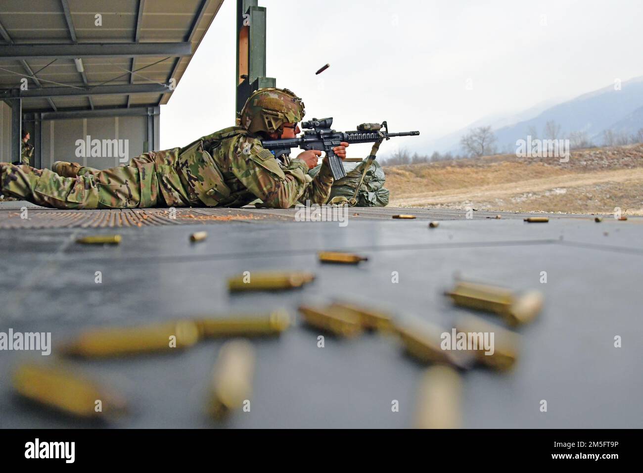 A U.S. Army Paratrooper, assigned to the 2nd Battalion, 503rd Infantry Regiment, 173rd Airborne Brigade, engages a pop-up targets with  an M4 carbine during marksmanship training at Cao Malnisio Range, Pordenone, Italy, March 15, 2022. The 173rd Airborne Brigade is the U.S. Army’s Contingency Response Force in Europe, providing rapidly deployable forces to United States European, African, and Central Command areas of responsibility. Stock Photo