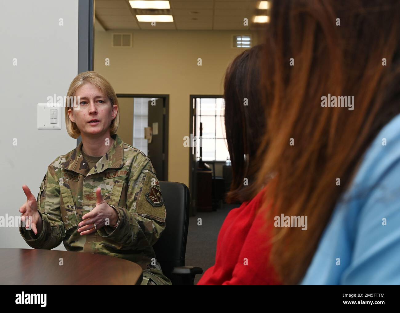 U.S. Air Force Col. Erica Rabe, 11th Wing and Joint Base Anacostia-Bolling vice commander, speaks to Commissioner Clara Botstein, director of legislation and government relations at the D.C. office of the deputy mayor for education; and Cherise Imai, executive director of the Military Interstate Children's Compact Commission, on March 15, 2022 about the base's first charter school, LEARN DC. Botstein and Imai also toured JBAB, Washington, D.C. and met members of the 11th Force Support Squadron in order to gain a deeper understanding of LEARN DC and the concerted interagency effort that made it Stock Photo