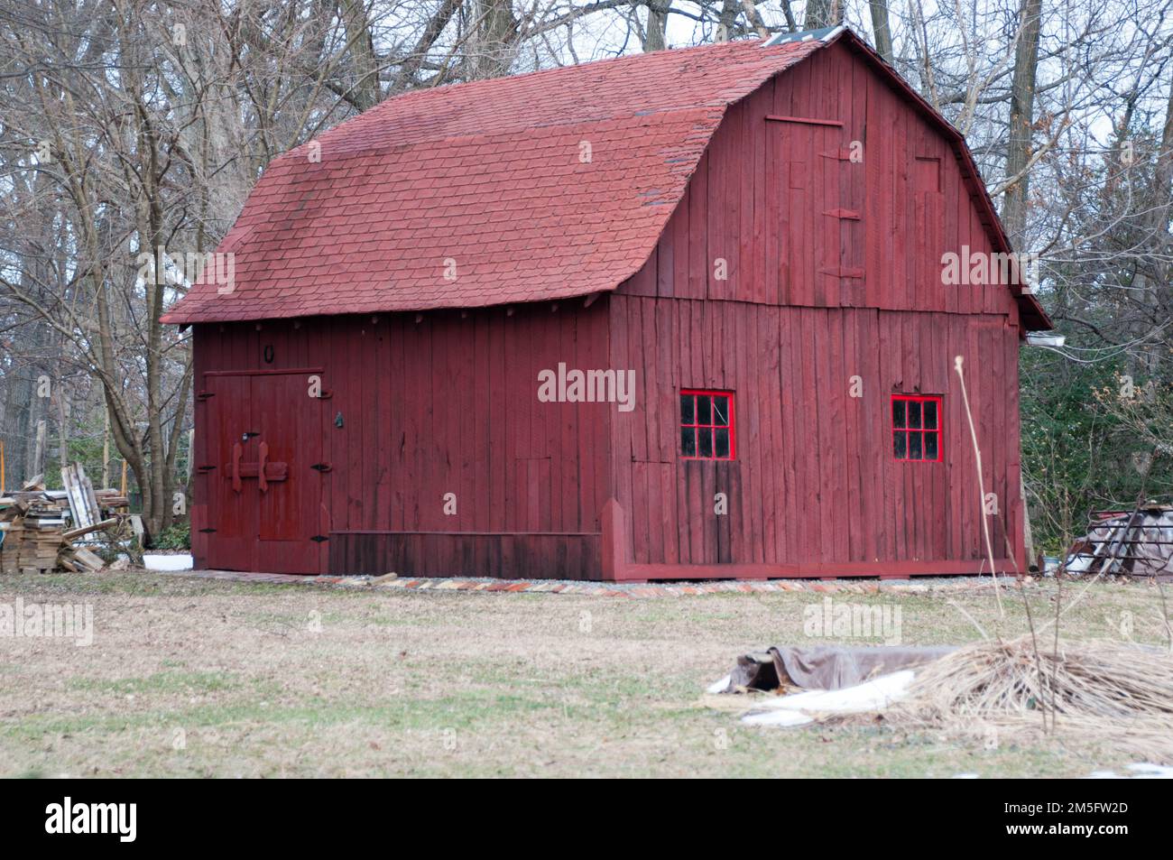 Red barn surviving in a suburban setting surrounded by housing for DC area workers. Stock Photo