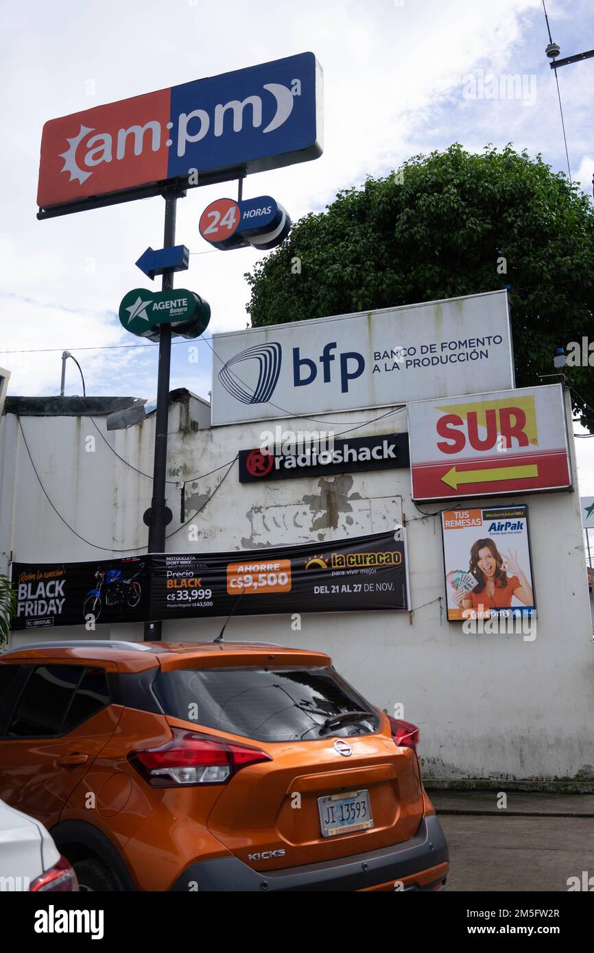 Small urban strip mall in Jinotega, Nicaragu has parking for non-pedestrian customers. Stock Photo