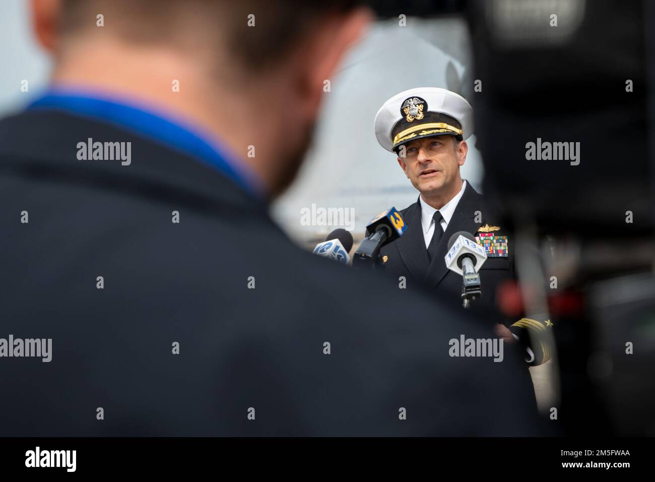 NORFOLK, Virginia – Capt. David Guluzian, Commander of the the Kearsarge Amphibious Ready Group (ARG) delivers remarks during a media interview prior to the Wasp-class amphibious assault ship USS Kearsarge (LHD 3) departing for deployment, Mar. 16, 2022. The Kearsarge ARG and 22nd Marine Expeditionary Unit (MEU) are operating in the Atlantic Ocean in support of naval operations to maintain maritime stability and security in order to ensure access, deter aggression and defend U.S., allied and partner interests. Stock Photo