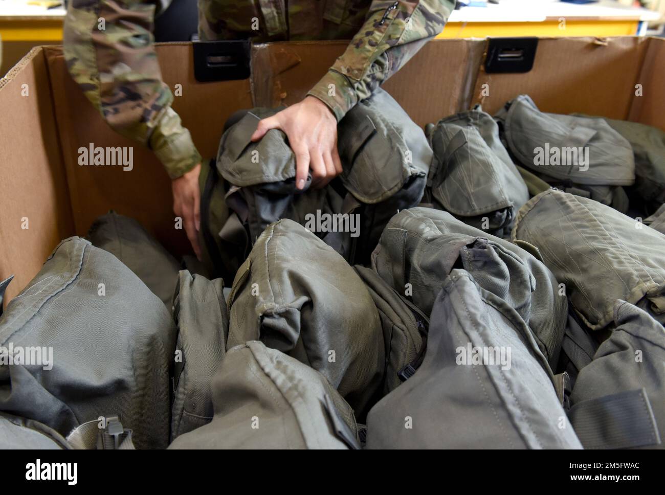 U.S. Air Force Airman 1st Class Kendrew Olboc, 100th Logistics Readiness Squadron Individual Protective Equipment apprentice, stacks old, turned-in gas masks ready to be shipped back to depot in the States at Royal Air Force Mildenhall, England, March 15, 2022. Airmen in the IPE shop support geographically separated units including RAF Croughton, and Stavanger, Norway, and issue all gear for chemical warfare assets to members tasked for deployments and TDYs, ensuring they are issued the correct equipment. Stock Photo