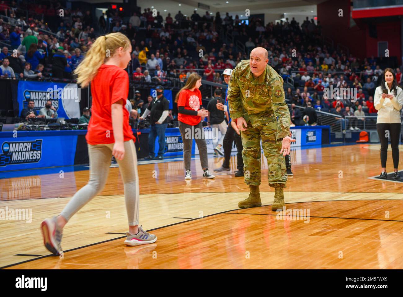 Col. Patrick Miller, 88th Air Base Wing commander, high-fives one of the Big Hoopla STEM Challenge finalists March 15, 2022, at University of Dayton Arena. Since 2012, the Big Hoopla has showcased Dayton’s collaborative spirit, community support and military appreciation as host of the NCAA men's basketball tournament First Four. Stock Photo