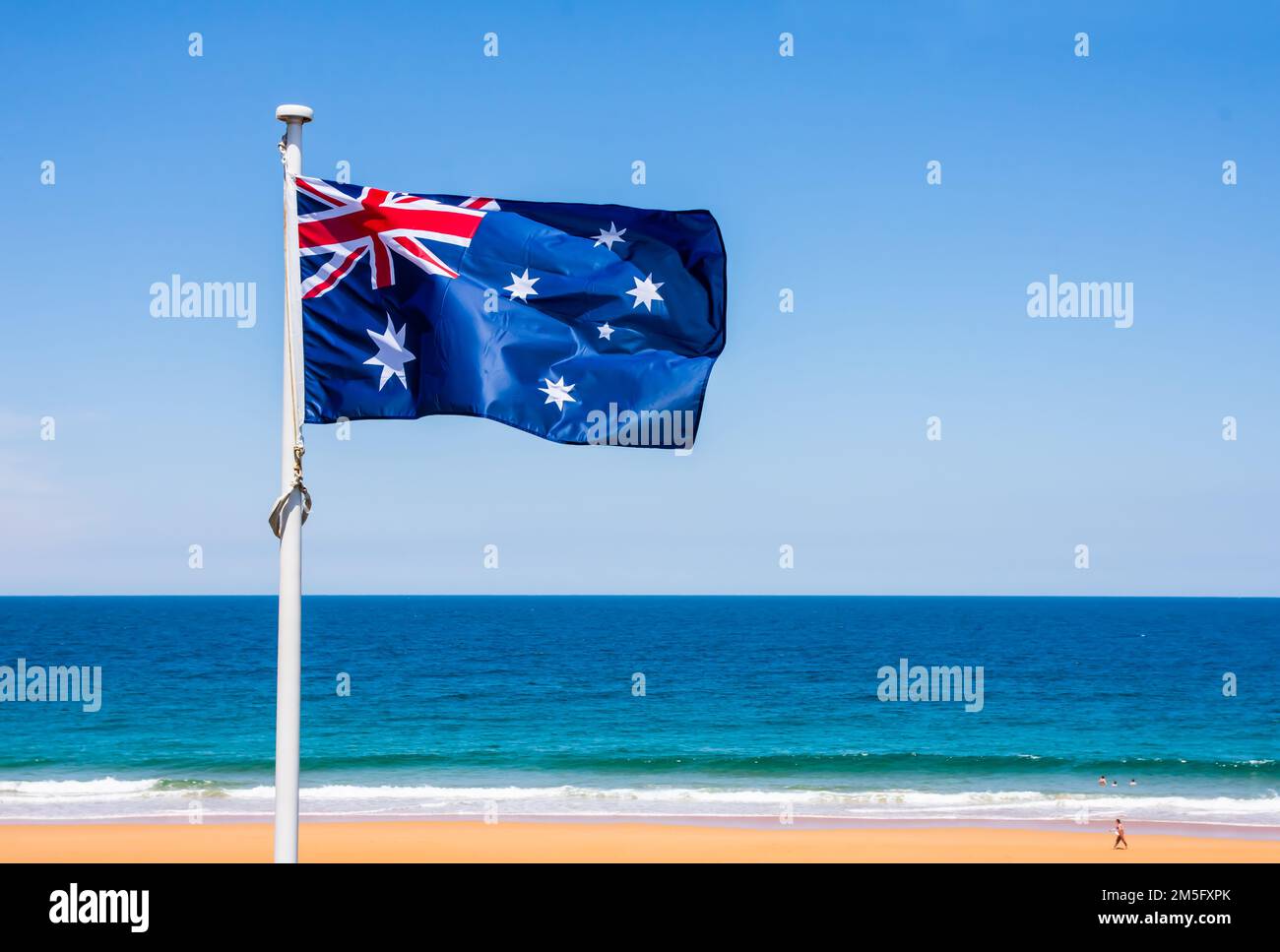 Australian flag with blue sky and beach Stock Photo