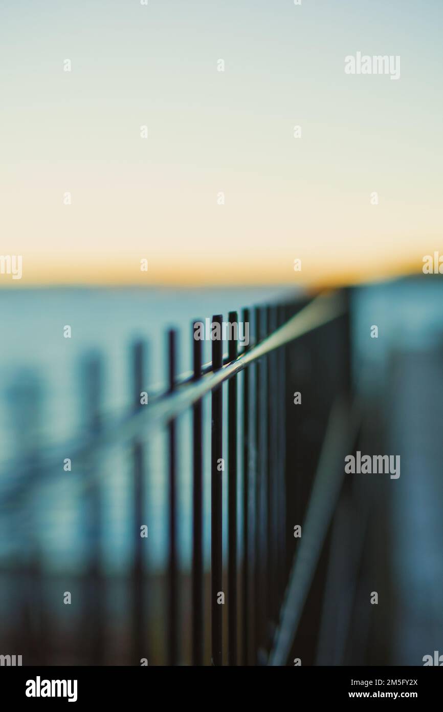 A vertical shot of outdoor metal fence on blurred background Stock ...
