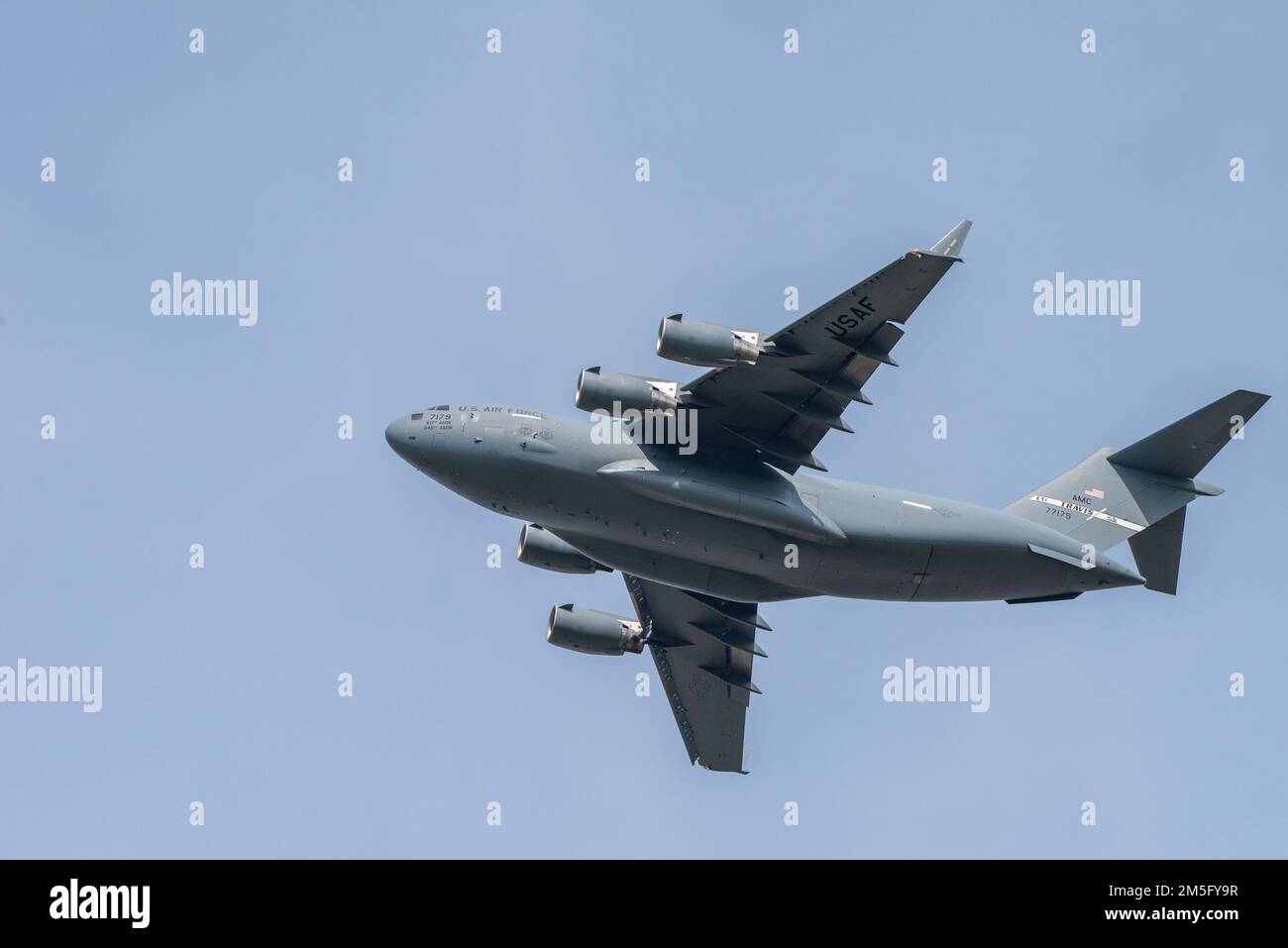 A U.S. Air Force C-17 Globemaster III conducts flight operations at Travis Air Force Base, California, March 15, 2022. This military airlift aircraft is a high-wing, four-engine, T-tailed military transport vehicle capable of carrying payloads up to 169,000 pounds. It has an international range and the ability to land on small airfields. A fully integrated electronic cockpit and advanced cargo system enables a crew of three to operate all systems on any type of mission. Stock Photo