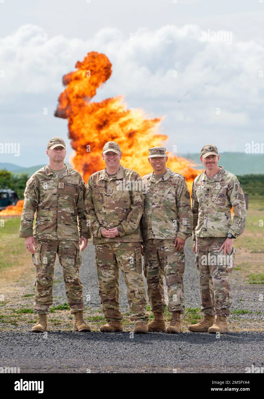 From left to right, U.S. Air Force Chief Master Sgt. Keith Scott, 60th Air Mobility Wing command chief, Col. Corey Simmons, 60th AMW commander, Col. Melvin Maxwell, 60th Mission Group commander and Lt. Col. Clint Townsend, 60th Civil Engineer Squadron commander, participate in a controlled Explosive Ordnance Disposal demonstration at Travis Air Force Base, California, March 15, 2022. Trained to detect, disarm and dispose of explosive threats in extreme environments, EOD technicians serve as the Air Force’s bomb squad. Stock Photo