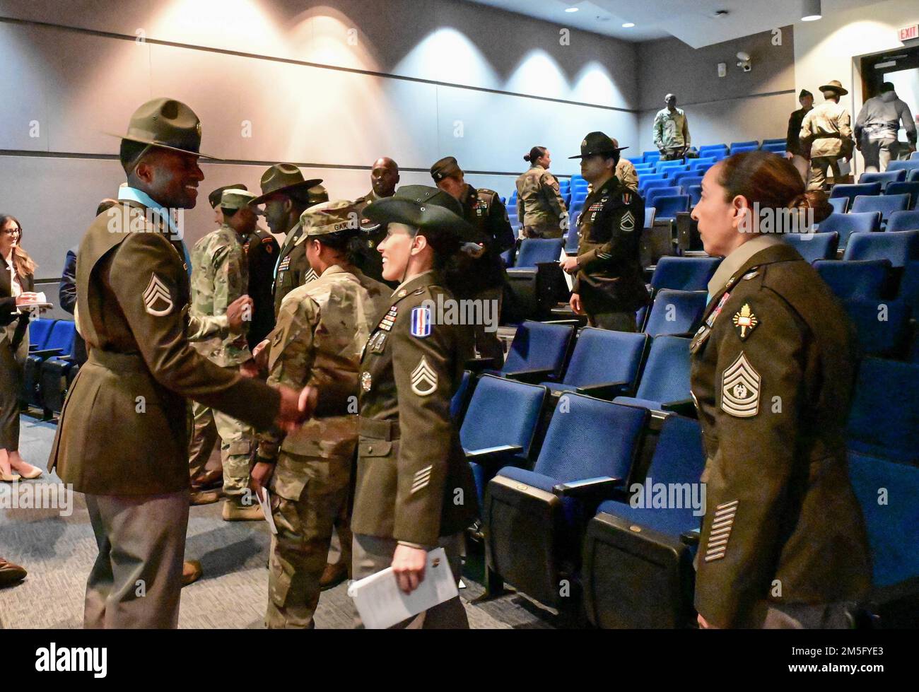 Staff Sgt. Devante McLean is congratulated by friends, unit members and Sergeant Audie Murphy Club members at the end of his induction ceremony. McLean was inducted into the SAMC Victory Chapter March 15, 2022, at the U.S. Army Institute for Religious Leaders auditorium. Stock Photo