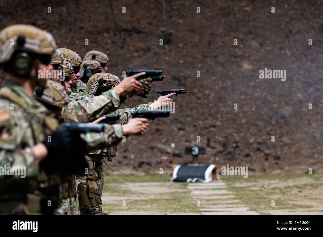 U.S. Air Force Airmen practice firing M9 pistols during exercise Scorpion Lens at Charleston, South Carolina, March 15, 2022. The 1st Combat Camera Squadron (1CTCS) holds Exercise Scorpion Lens annually to provide expeditionary skills training to Combat Camera Airmen. Stock Photo