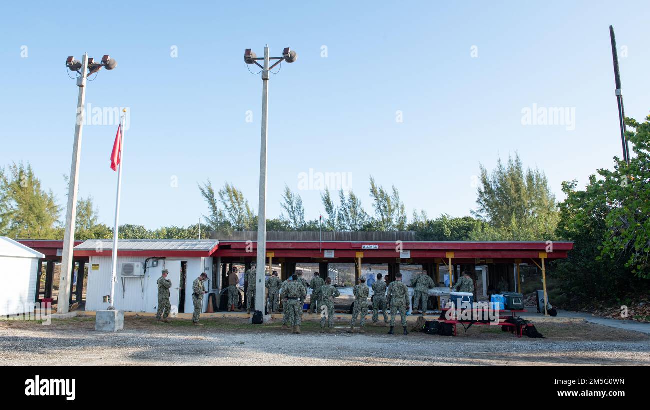 (220315-N-OI810-0431) KEY WEST, Florida (March 15, 2022) Seabees assigned to Naval Mobile Construction Battalion (NMCB) 14 conduct weapons qualification for the M-18 service pistol at Boca Chica Field small arms range, Naval Air Station Key West (NASKW), March 15, 2022. Seabees assigned to NMCB-14 travelled to NASKW to complete a week-long course to increase combat readiness and qualify members in the M-18 pistol and M-4 rifle small arms platforms. NMCB-14 provides advance base construction, battle damage repair, contingency engineering, humanitarian assistance and disaster recovery support to Stock Photo