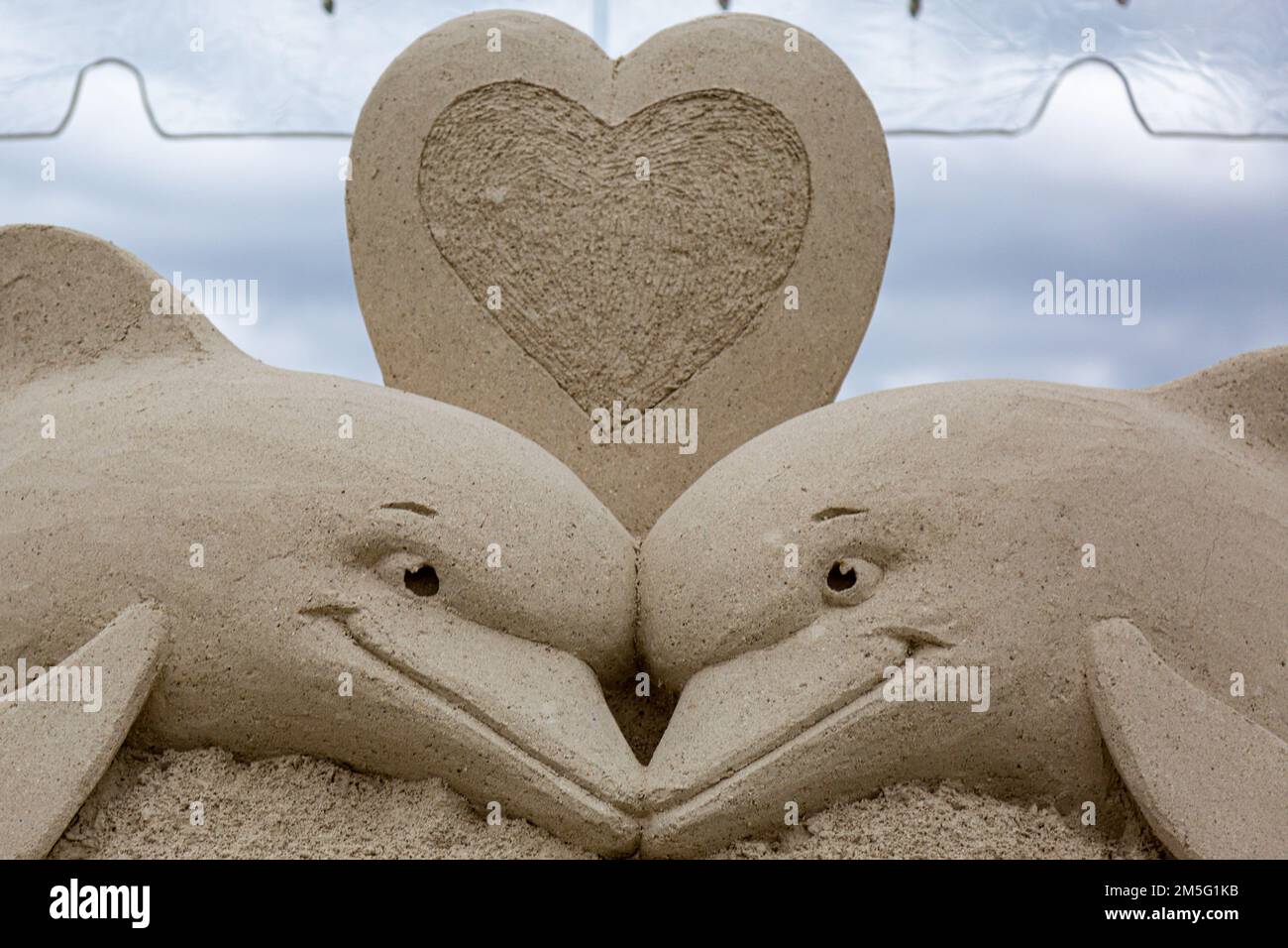 A sand sculpture by Mark Mason and Team Sandtastic depict two dolphins in love in West Palm