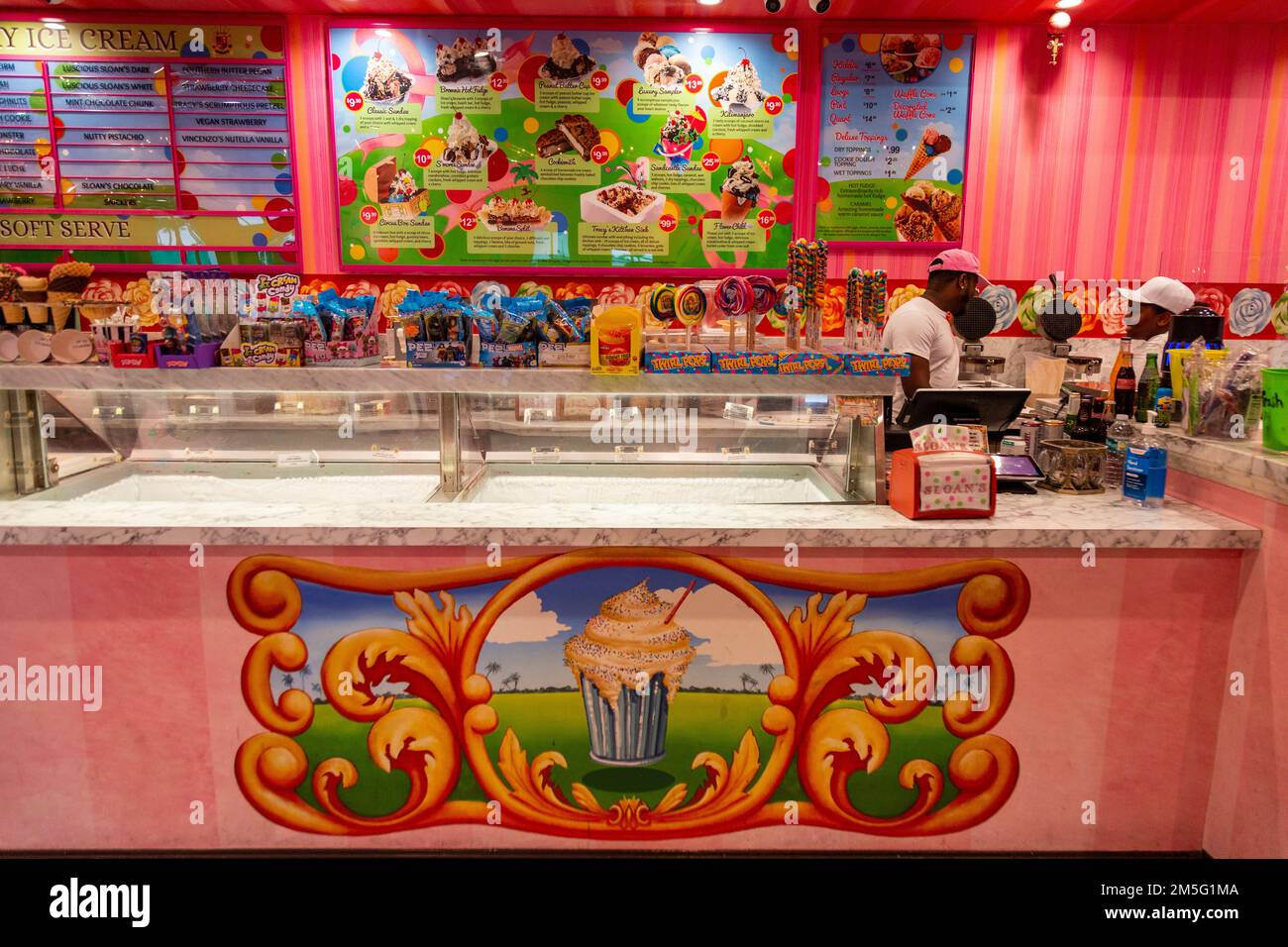 Employees working behind the counter in the bright pink Sloan's Ice