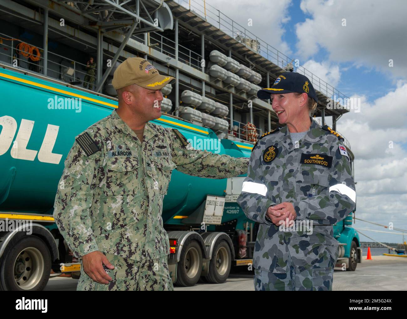 BRISBANE, Australia (March 16, 2022) U.S. Navy Capt. Al Alarcon, commanding officer of the Emory S. Land-class submarine tender USS Frank Cable (AS 40), speaks with Royal Australian Navy Cmdr. Fiona Southwood, the commanding officer of HMAS Moreton, prior to a tour of Frank Cable, March 16. Frank Cable is currently on patrol conducting expeditionary maintenance and logistics in support of national security in the U.S. 7th Fleet area of operations Stock Photo