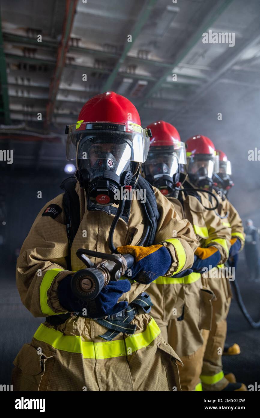 220317-N-UK596-1383  NEWPORT NEWS, Va. (March 17, 2022) – Sailors aboard the Nimitz-class aircraft carrier USS George Washington (CVN 73) man the hose while the ship is conducting a simulated at-sea training exercise during a general quarters drill. George Washington is undergoing refueling complex overhaul (RCOH) at Newport News Shipyard. RCOH is a multi-year project performed only once during a carrier’s 50-year service life that includes refueling the ship’s two nuclear reactors, as well as significant repairs, upgrades, and modernization. Stock Photo