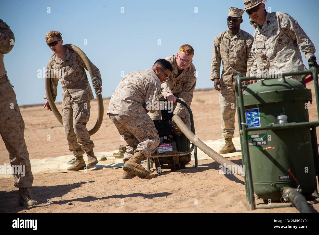 U.S. Marines assigned to Aviation Ground Support, Marine Aviation Weapons and Tactics Squadron One (MAWTS-1) conduct a forward arming and refueling point (FARP) practical application, during Weapons and Tactics Instructor (WTI) course 2-22, at Auxiliary Airfield II, near Yuma, Arizona, March 16, 2022. WTI is a seven-week training event hosted by MAWTS-1, providing standardization advanced tactical training and certification of unit instructor qualifications to support Marine aviation training and readiness and assist in developing and employing aviation weapons and tactics. Stock Photo