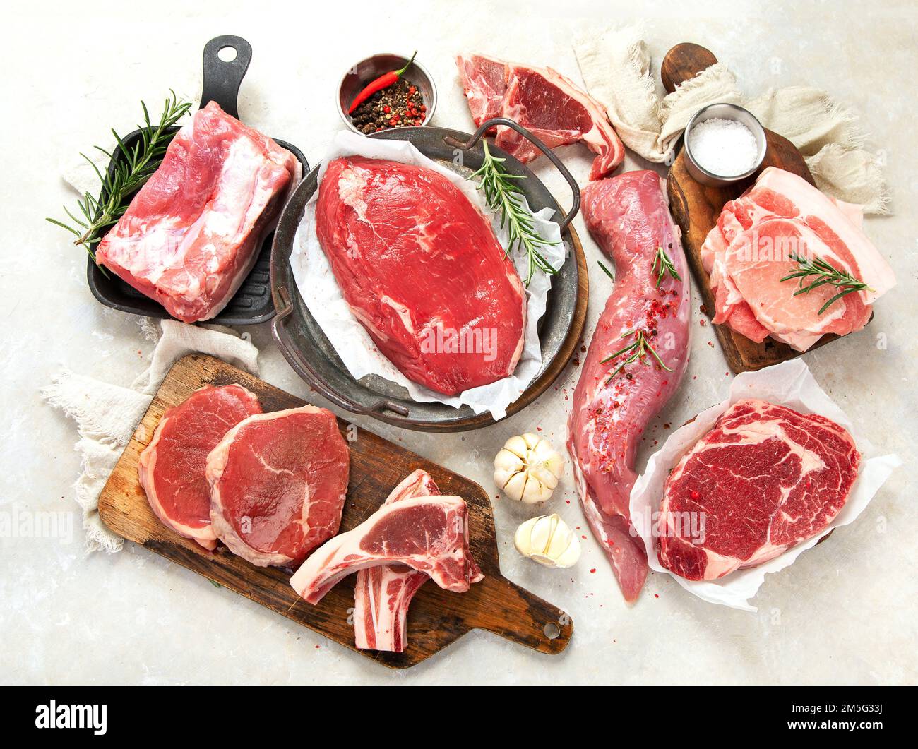 Various types of fresh meat pork, beef and chicken on a grey background. Top view Stock Photo