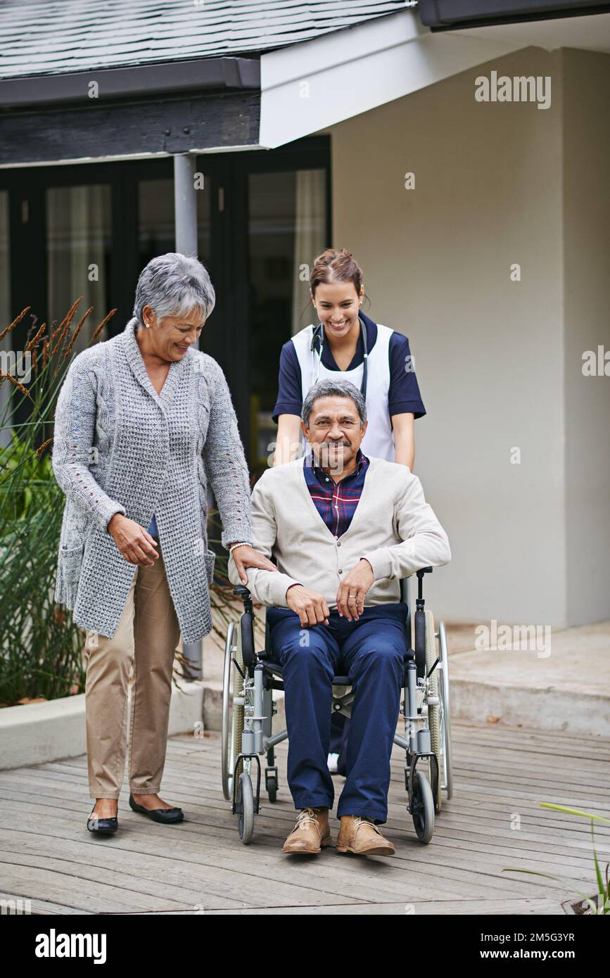 Settling into his new home. a senior woman and her husband with a nurse at a retirement home. Stock Photo