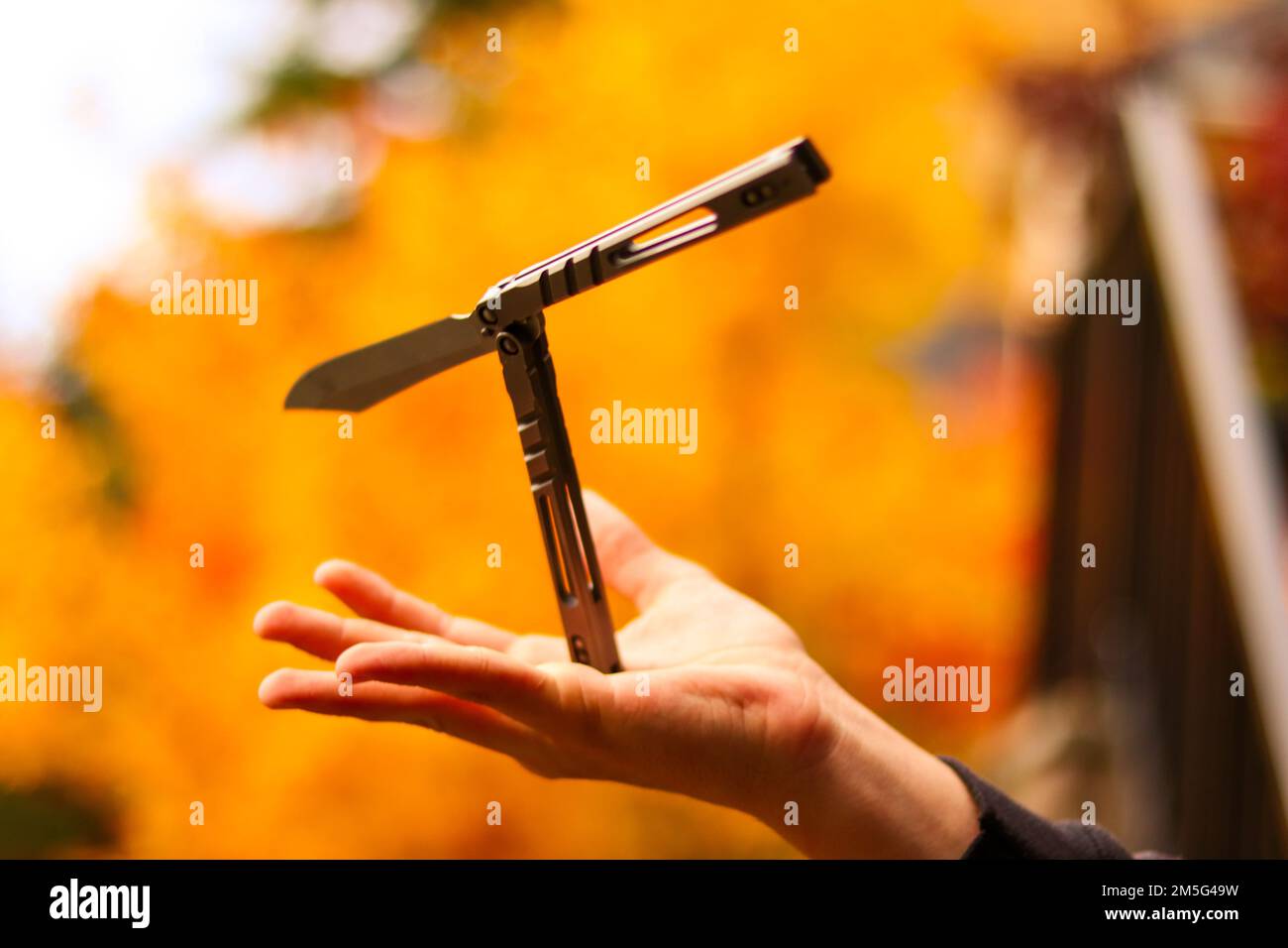 A balisong knife on human hand Stock Photo Alamy