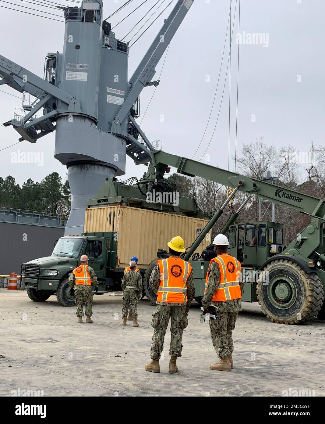 220316-N-LL092-1001 WILLIAMSBURG, Va. (March. 16, 2022) – Reserve Sailors from Navy Cargo Handling Battalion (NCHB) 13, participate in a Unit Level Training Readiness Assessment on Cheatham Annex. Sailors practice loading and offloading cargo containers. NCHB-13 is one of seven battalions under Navy Expeditionary Logistics Support Group (NAVELSG). NAVELSG provides expeditionary logistics capabilities for the Navy and joint service customers. Stock Photo