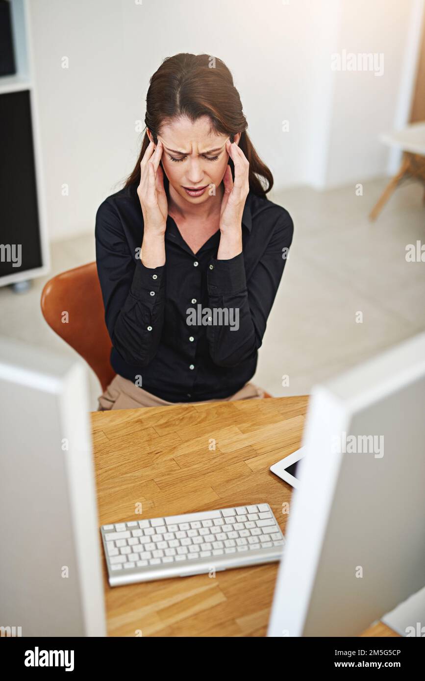 This workday just isnt working out. a young businesswoman having a bad day at work. Stock Photo