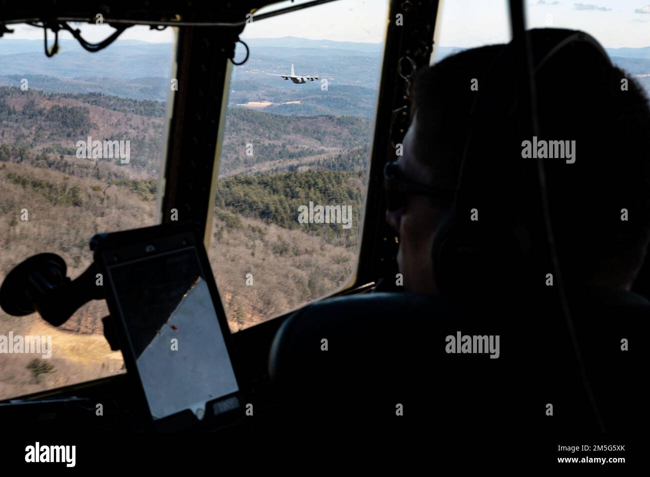 Air Force Lt. Col. Joshua Panis, a pilot assigned to the 103rd Airlift Wing, pilots a C-130H aircraft during an airdrop training mission, March 17, 2022, East Granby, Conn. Airdrops are used to expeditiously deliver vital assets. Stock Photo