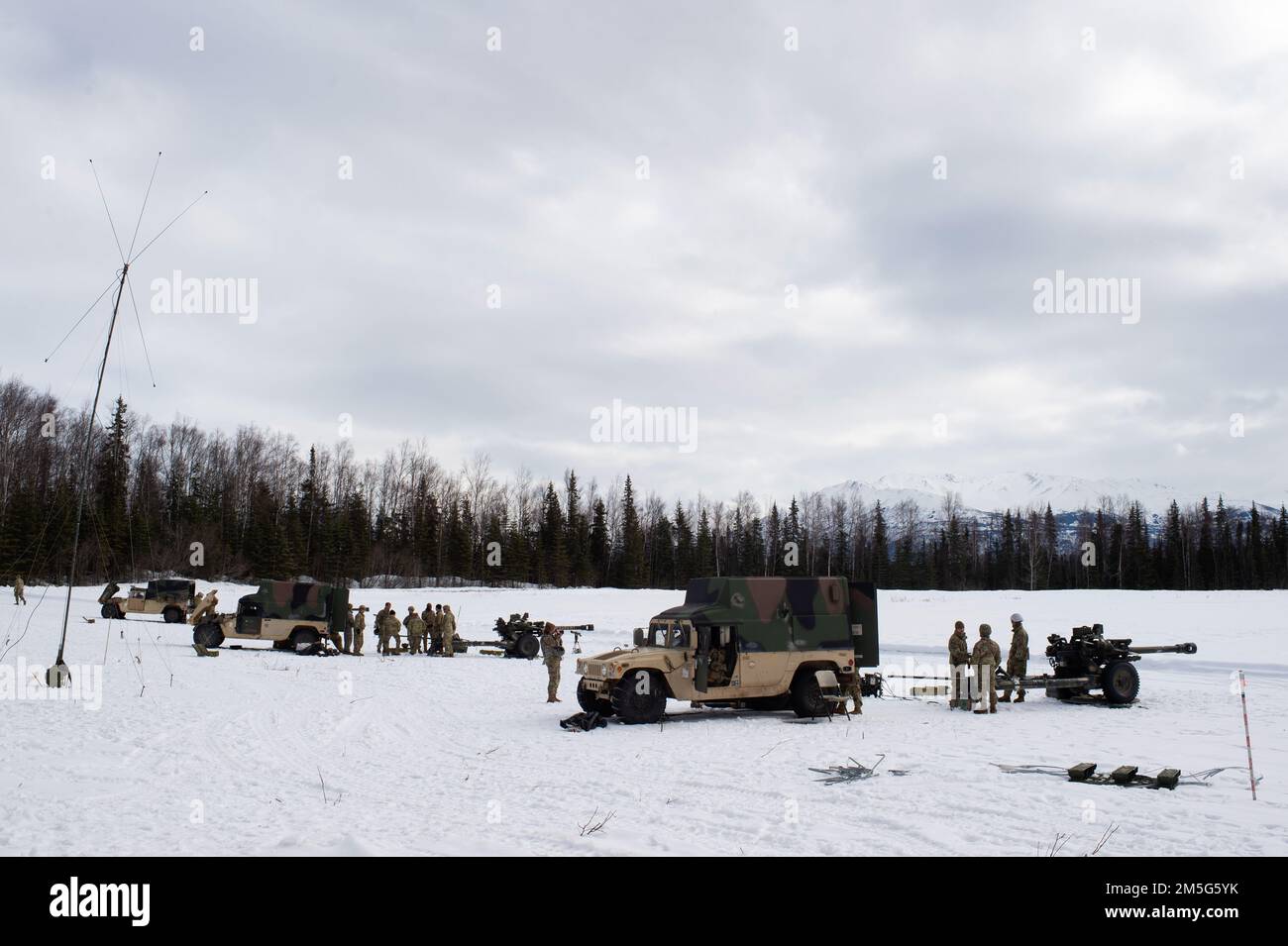 U.S. Army paratroopers assigned to Bravo Battery, 2nd Battalion, 377th Parachute Field Artillery Regiment, 4th Infantry Brigade Combat Team (Airborne), 25th Infantry Division, U.S. Army Alaska, stage for live-fire artillery training at Joint Base Elmendorf-Richardson, Alaska, March 16, 2022. The Soldiers of 4/25 belong to the only American airborne brigade in the Pacific and are trained to execute airborne maneuvers in extreme cold weather and high altitude environments in support of combat, partnership and disaster relief operations. Stock Photo