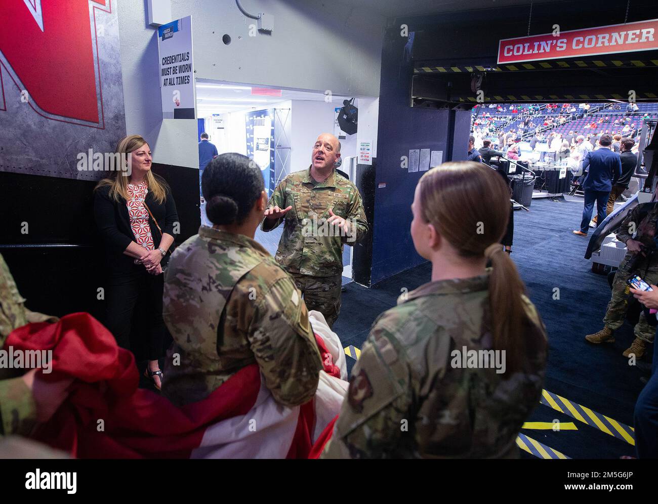 Col. Patrick Miller, 88th Air Base Wing and Wright-Patterson Air Force Base commander, visits with some of his Airmen before they carry a large American flag out onto the floor of University of Dayton Arena on March 16, 2022, for the opening ceremony of the NCAA men’s basketball tournament game between Wright State and Bryant. The Air Force was also represented by the Wright-Patterson Honor Guard. Stock Photo