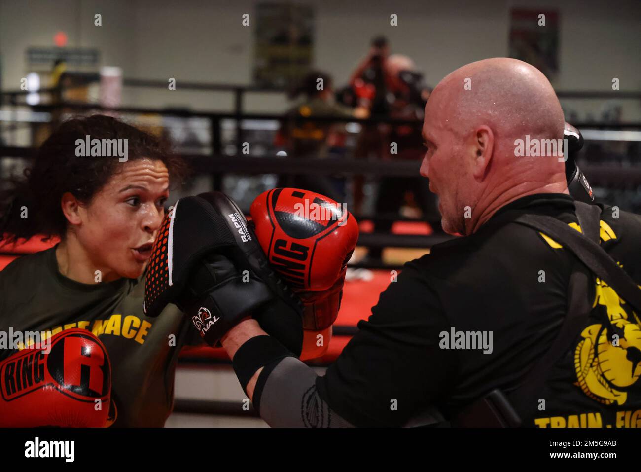 U.S. Marine Corps 1st Lt. Stephanie Simon, the team captain of II Marine Expeditionary Force Martial Arts Center of Excellence boxing team, practices her techniques with Joseph Higgins, the II MEF MACE boxing team coach, Camp Lejeune, N.C., March 16, 2022. Simon is the two-time National Champion in boxing and keeping her skills sharp is essential for her success. Stock Photo