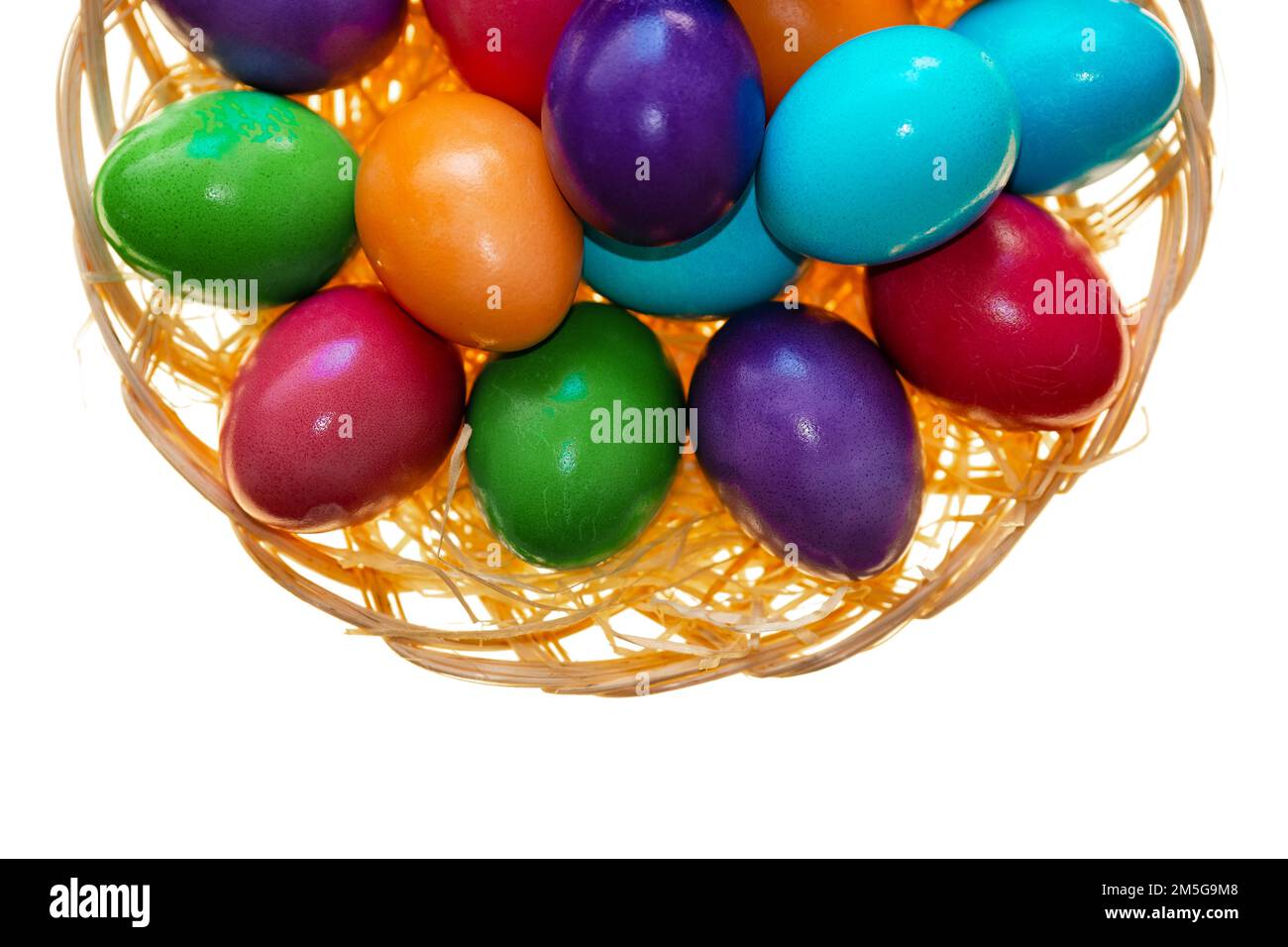 Easter tradition.multicolored painted eggs close-up in a bowl on a white background.Easter food. Spring religious holiday symbol. Christian and Stock Photo