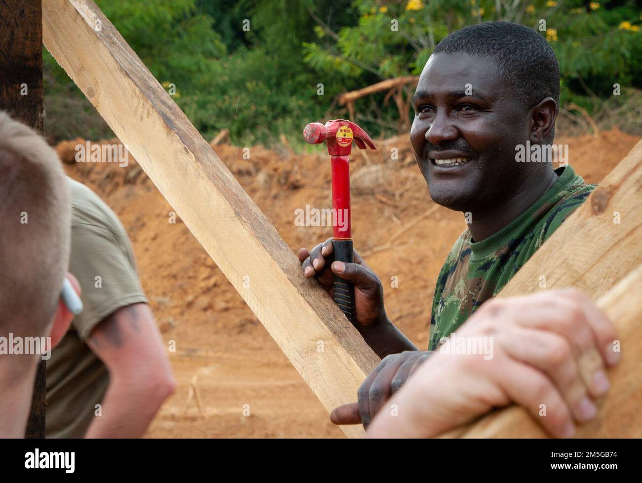 A Soldier from the Rwanda Defense Force's Engineer Brigade smiles while ...