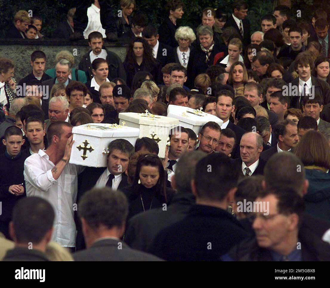 File photo dated 14/07/98 of the three coffins of brothers Richard, Mark, Jason Quinn who were killed in a sectarian arson attack are carried by family and mourners to Rasharkin Church for burial, after leaving a funeral mass at the Church of Our Lady and St Patricks, Ballymoney. The murders of three young children in Ballymoney were recorded as having 'changed the mood' in Northern Ireland following a period of sustained violence at the height of the Drumcree standoff in 1998 Issue date: Thursday December 29, 2022. Stock Photo