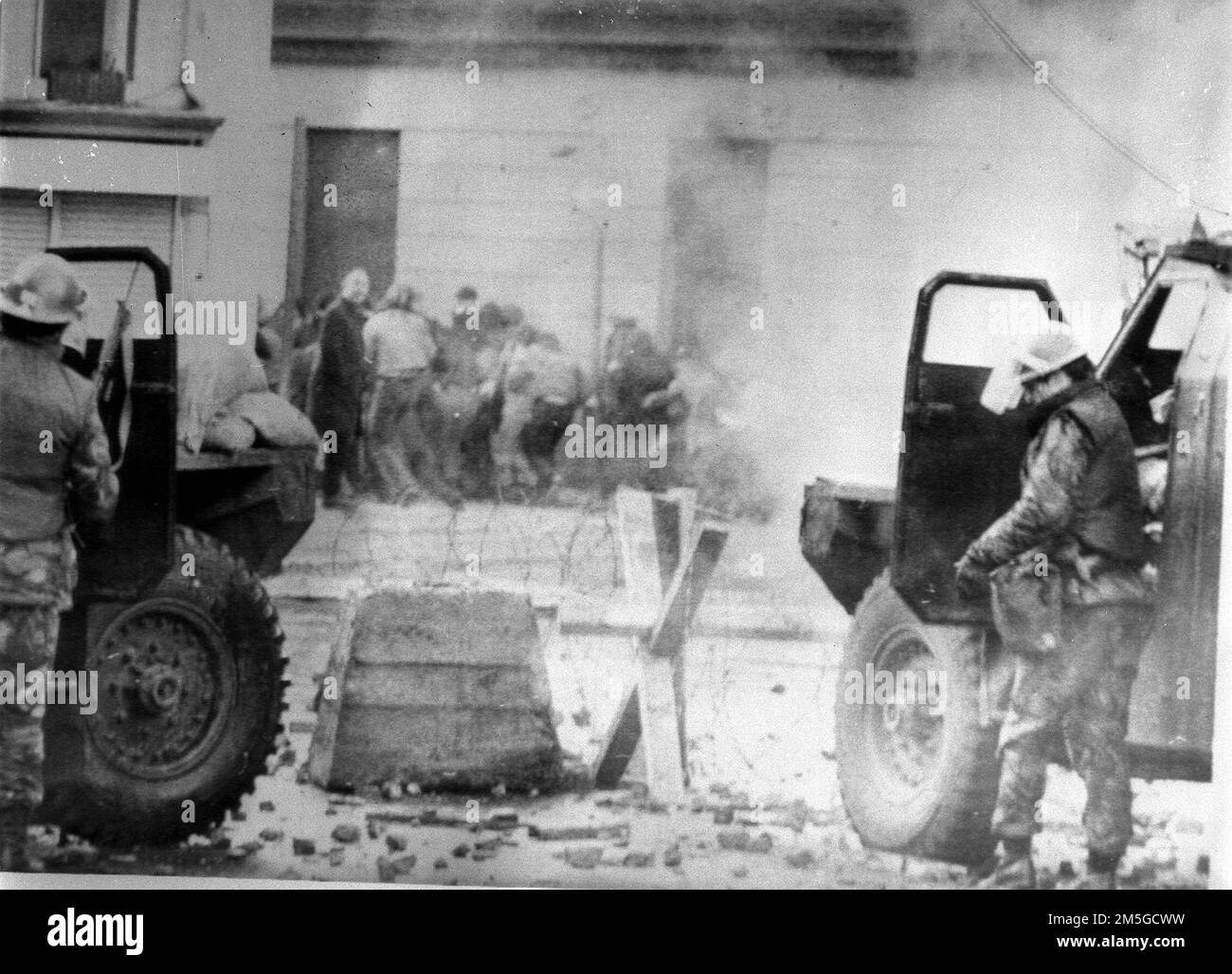 File photo dated 30/01/72 of soldiers taking cover behind their sandbagged armoured cars while dispersing rioters with CS gas in Londonderry, where an illegal civil rights march culminated in a clash between troops and demonstators, which resulted in 13 men being shot dead. Northern Ireland Office ministers wrote to the Treasury in 1998 and 1999 seeking assurances that it would cover the spiralling costs of the Bloody Sunday Inquiry, newly released Government papers have revealed. Issue date: Thursday December 29, 2022. Stock Photo