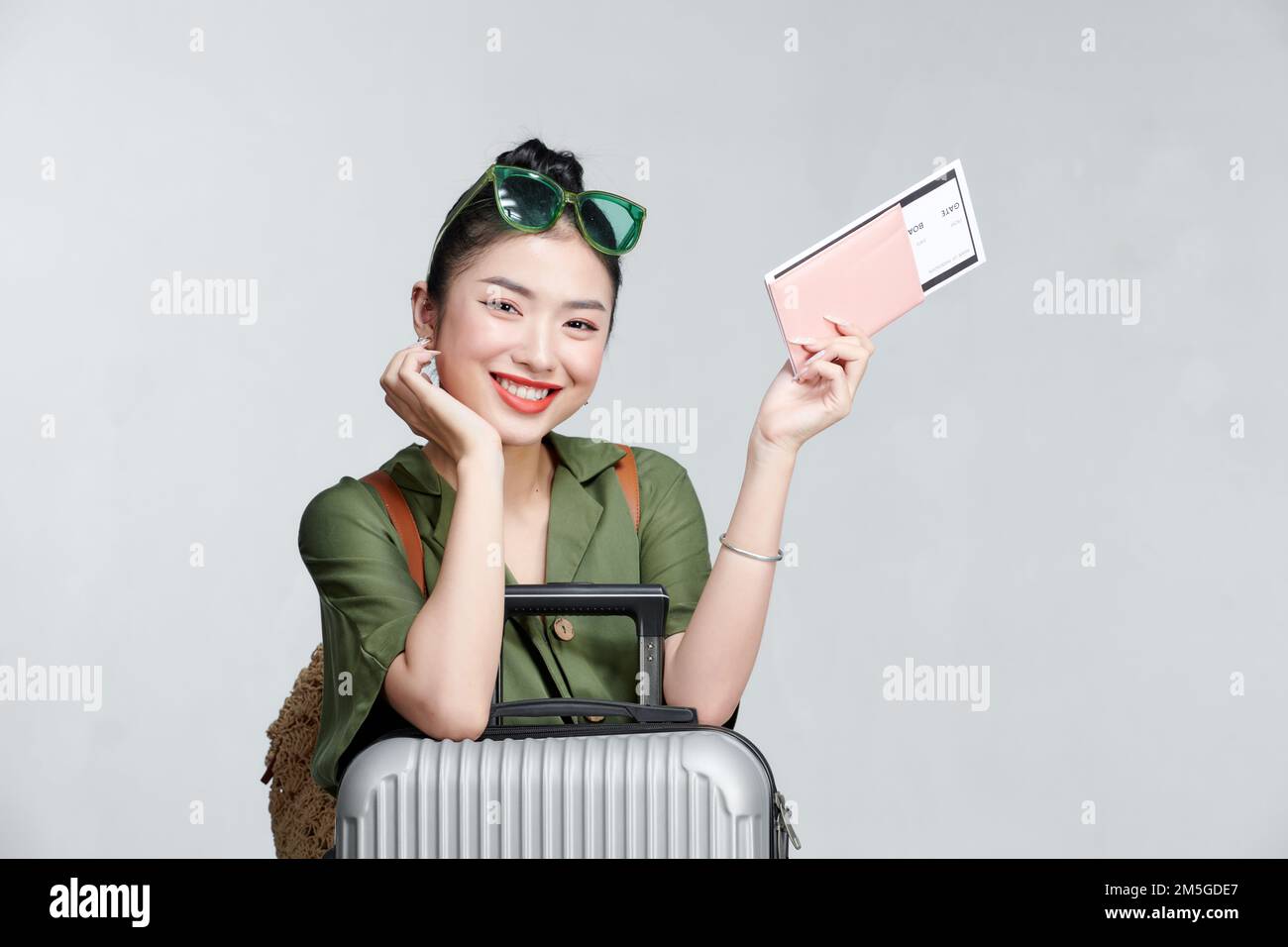 Portrait of nice smiling woman holding passport and flying tickets Stock Photo