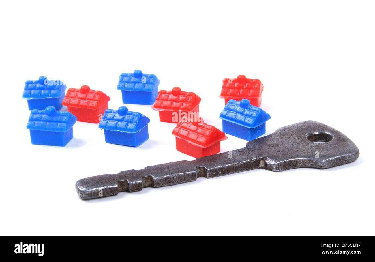 Home Ownership Concept with old key and toy houses Stock Photo