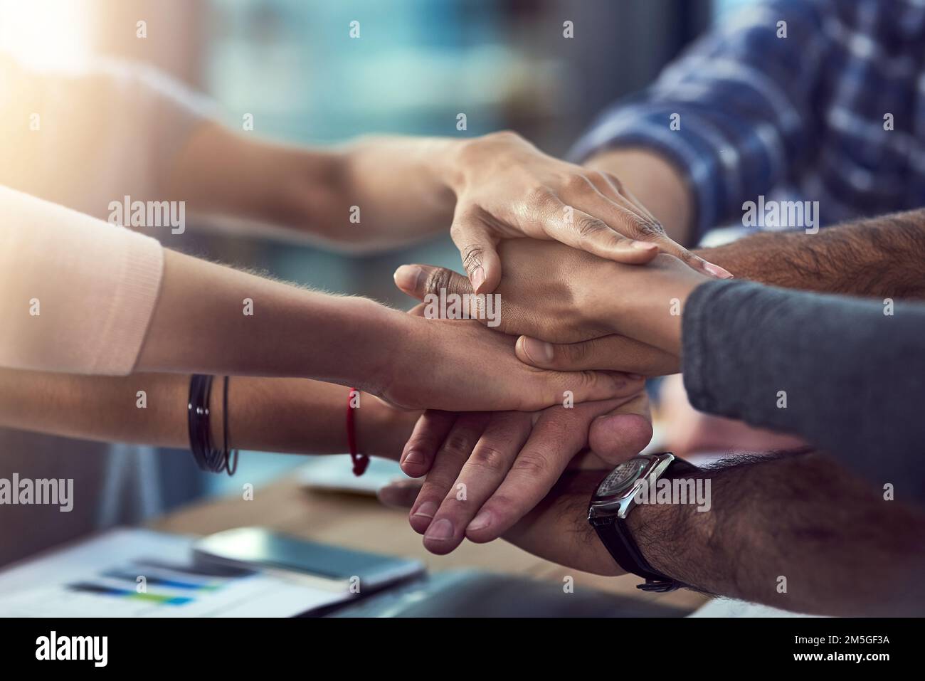 Its all about teamwork a group of peoples hands in a huddle stock
