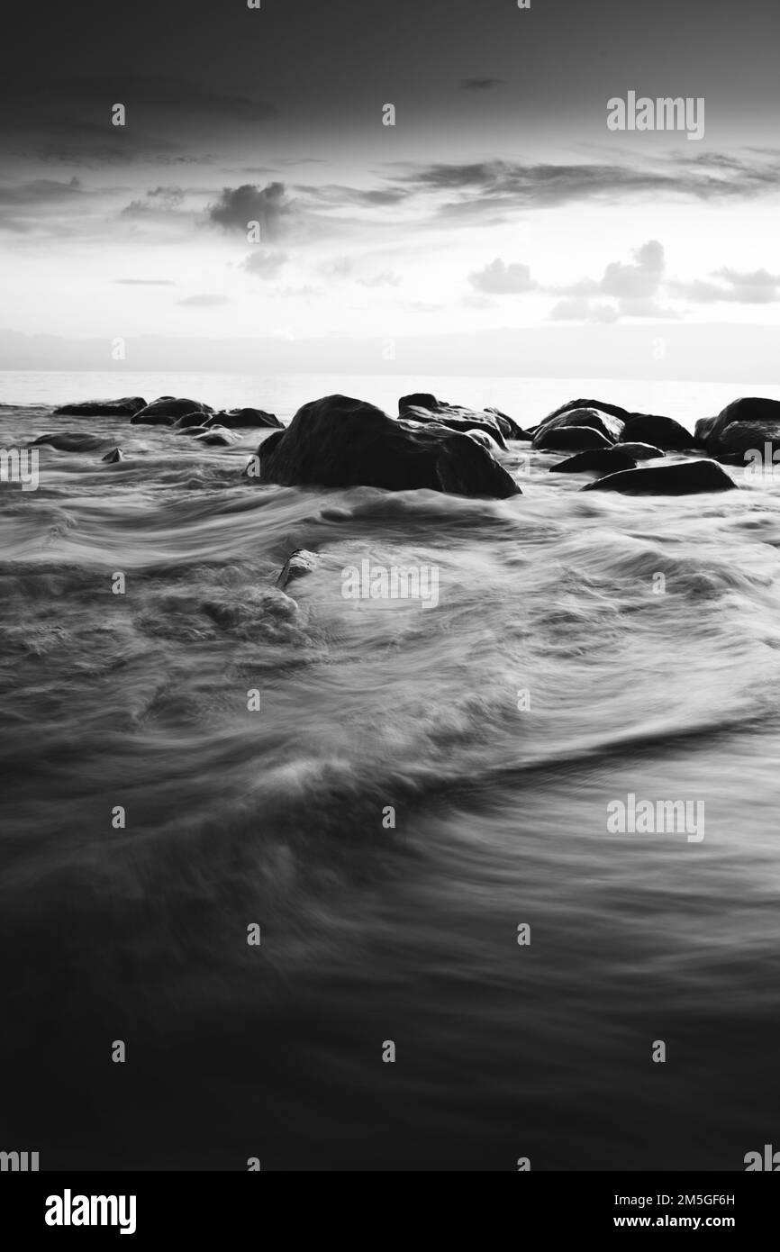 A black and white view of rocky ocean water Stock Photo - Alamy