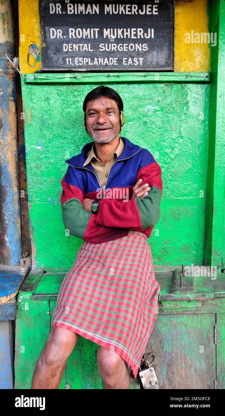 A smiling Bengali man dressed in a traditional lungi. Kolkata, India