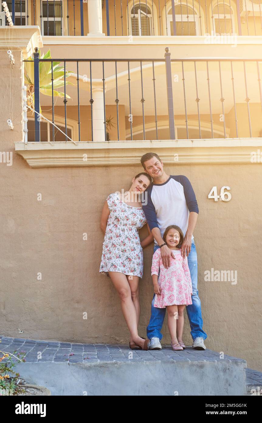 Were a loving family. Portrait of a happy family standing outside their house. Stock Photo